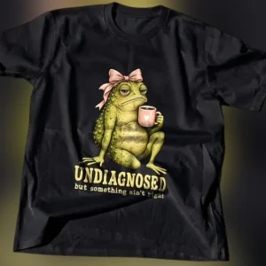 Undiagnosed But Something Ain't Right Grumpy Toad Graphic Tee, Funny Sarcastic Mental Health Meme T- available at our Los Angeles warehouse