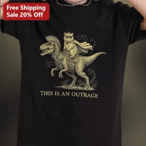 This Is An Outrage Vintage Cat Riding Dinosaur Graphic Tee Funny Sarcastic Meme Shirt Gift available at our Los Angeles warehouse