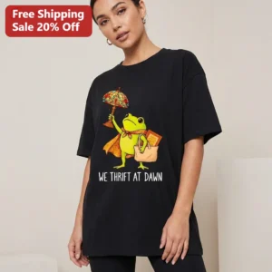 We Thrift At Dawn Tee Funny Frog Meme Vintage Stained Glass Lamp Thrifting Graphic Shirt available at our Los Angeles warehouse
