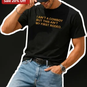 I Ain't A Cowboy But This Ain't My First Rodeo Funny Country Music Graphic Tee for Men available at our Los Angeles warehouse