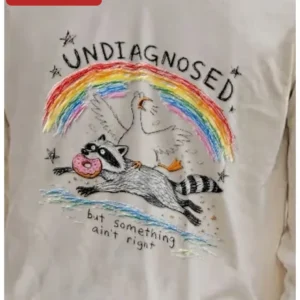 Undiagnosed But Something Ain't Right Funny Raccoon Goose Graphic Tee ADHD Mental Health Gift available at our Los Angeles warehouse